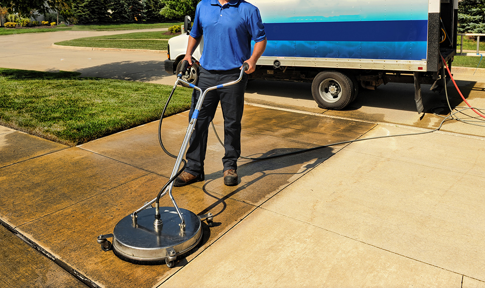 Image of driveway getting pressure washed - Bel Tex Soft Wash